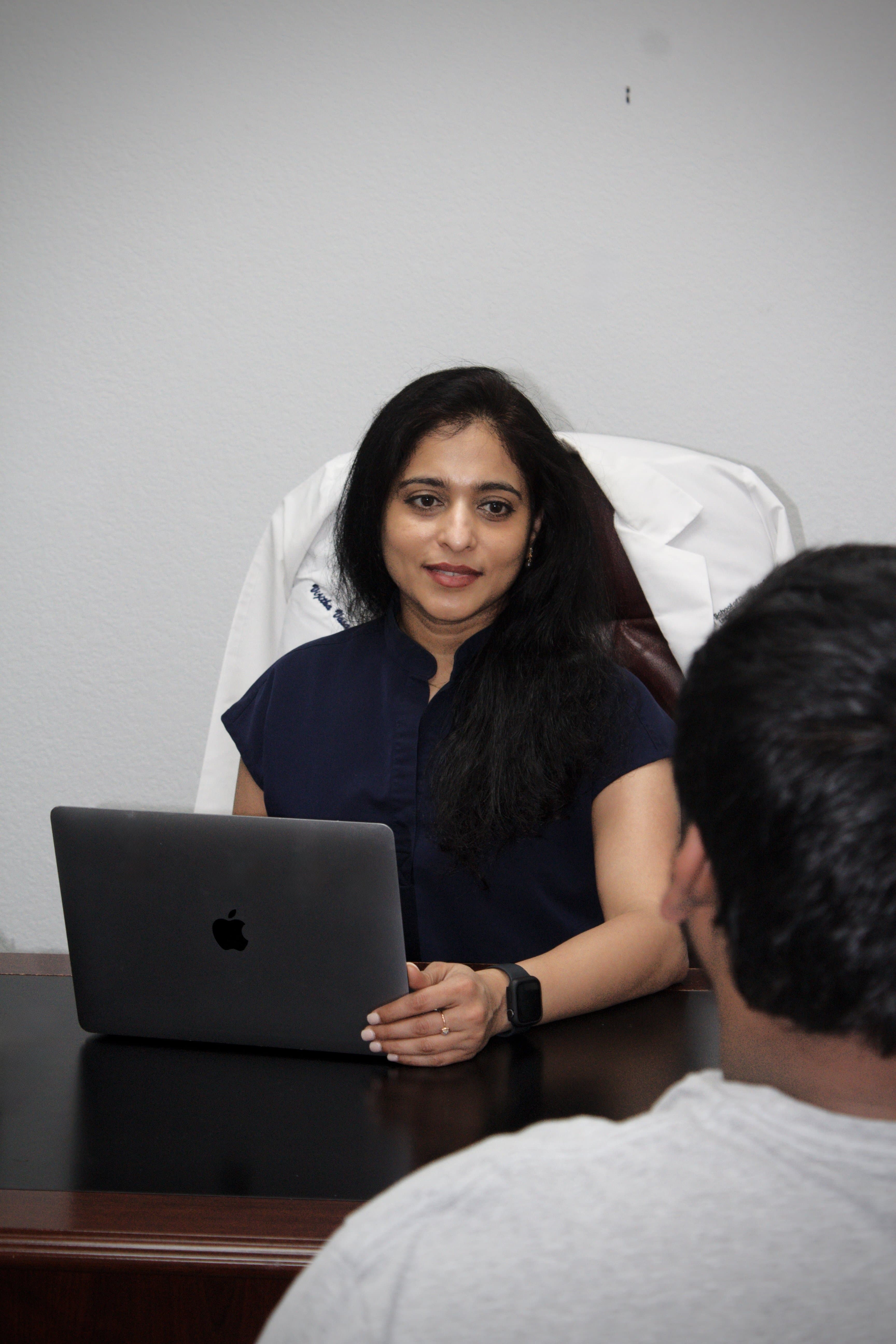 Dr. Vasantha consulting with a patient